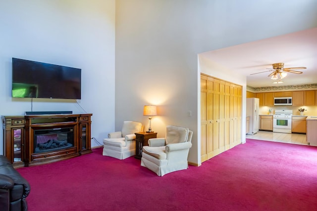 534 Philip Dr, Bartlett, IL 60103 - living area with light carpet, ceiling fan, and a glass covered fireplace