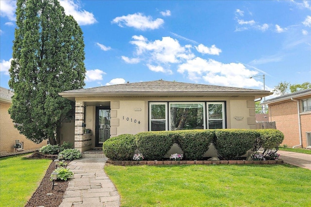 10104 Maple Ave, Oak Lawn, IL 60453 - bungalow with stucco siding and a front yard