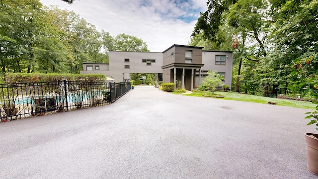 view of front of house with fence and a fenced in pool