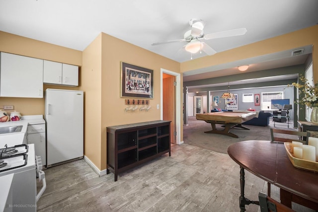 interior space featuring pool table, ceiling fan, light wood-style flooring, and visible vents