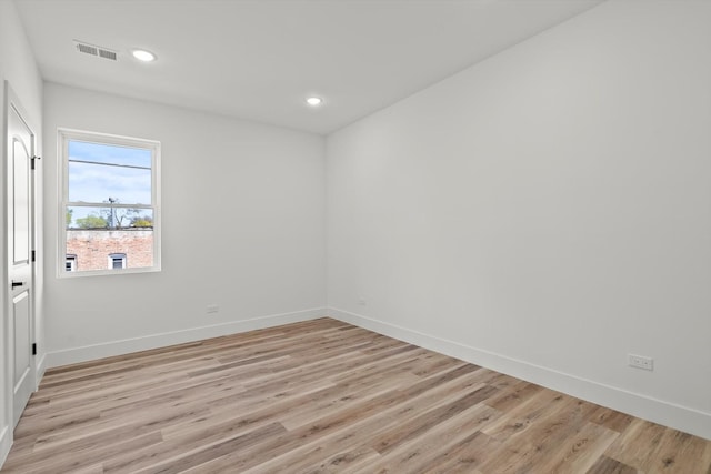 spare room featuring recessed lighting, baseboards, visible vents, and light wood-type flooring