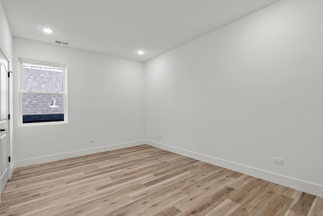 unfurnished room with recessed lighting, baseboards, light wood finished floors, and visible vents