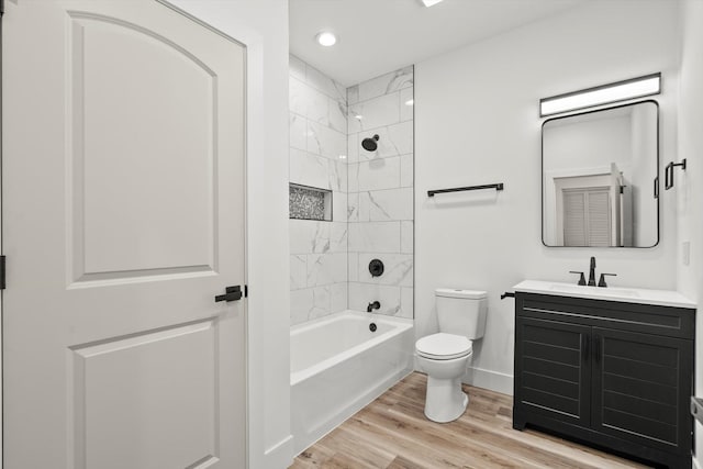 full bathroom featuring wood finished floors, vanity, baseboards, toilet, and recessed lighting