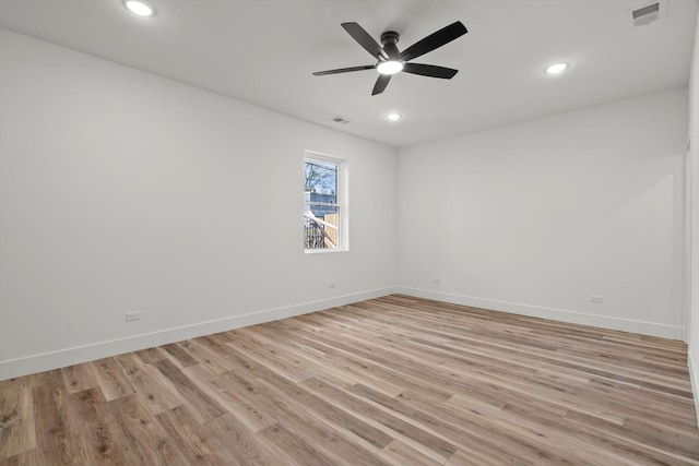 unfurnished room with light wood-style floors, recessed lighting, and visible vents