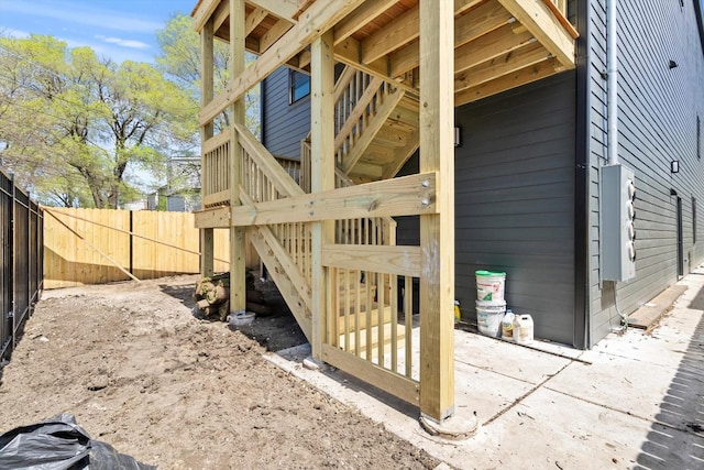 view of home's exterior with a patio area and fence