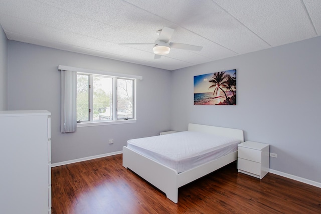 bedroom featuring baseboards, a ceiling fan, and wood finished floors