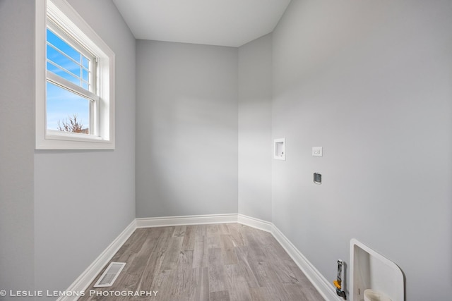 laundry room featuring washer hookup, laundry area, visible vents, baseboards, and wood finished floors
