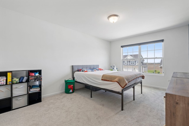 bedroom with carpet floors and baseboards