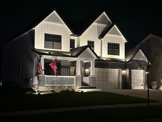 view of front facade with a porch, a garage, board and batten siding, and concrete driveway