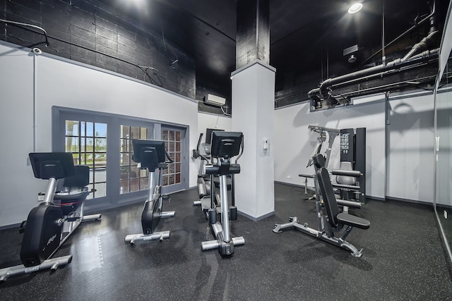 workout area with a high ceiling and french doors