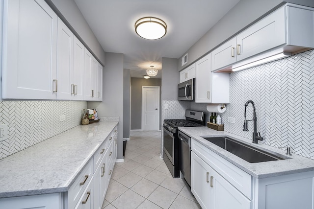 kitchen featuring appliances with stainless steel finishes, light tile patterned floors, and tasteful backsplash