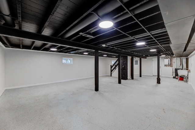 basement with baseboards and a sink