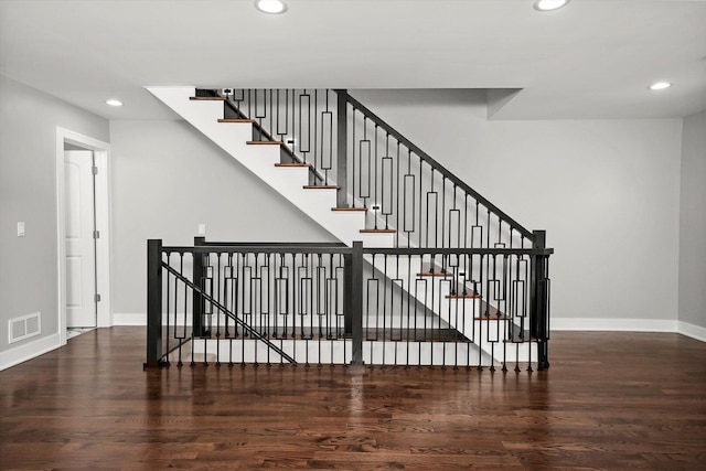 stairway with wood finished floors, visible vents, baseboards, and recessed lighting