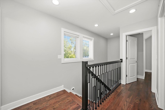 hallway featuring baseboards, an upstairs landing, recessed lighting, and wood finished floors