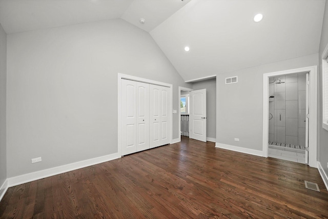 unfurnished bedroom with a closet, high vaulted ceiling, visible vents, and wood finished floors