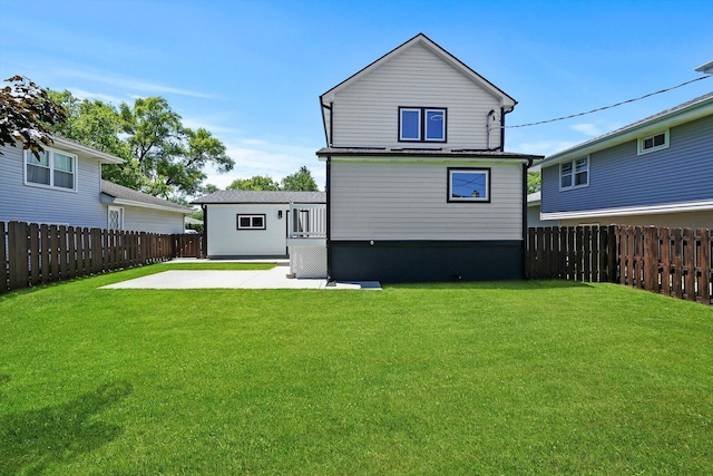 rear view of property featuring a fenced backyard, a patio area, and a lawn