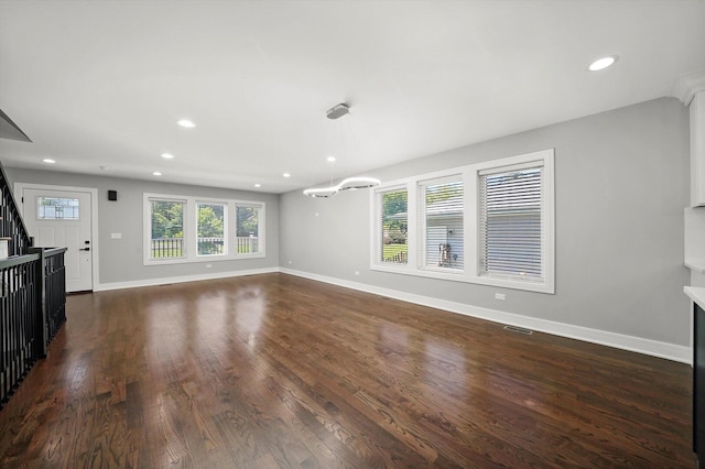 unfurnished living room with stairway, baseboards, dark wood-type flooring, and recessed lighting
