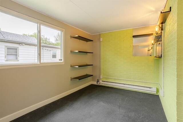 1306 Ewing St, Bloomington, IL 61701 - empty room with dark colored carpet, baseboards, crown molding, and baseboard heating