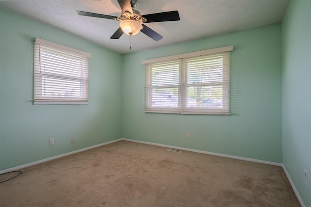 1306 Ewing St, Bloomington, IL 61701 - empty room with baseboards, a ceiling fan, and carpet