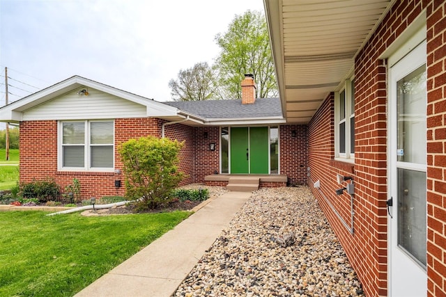 1306 Ewing St, Bloomington, IL 61701 - entrance to property with a shingled roof, a chimney, a yard, and brick siding