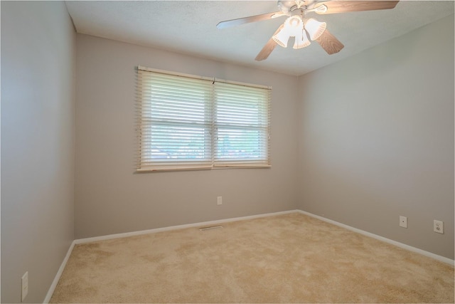 1306 Ewing St, Bloomington, IL 61701 - carpeted empty room with baseboards, ceiling fan, and visible vents