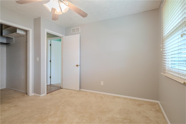 1306 Ewing St, Bloomington, IL 61701 - unfurnished bedroom with baseboards, carpet flooring, and visible vents