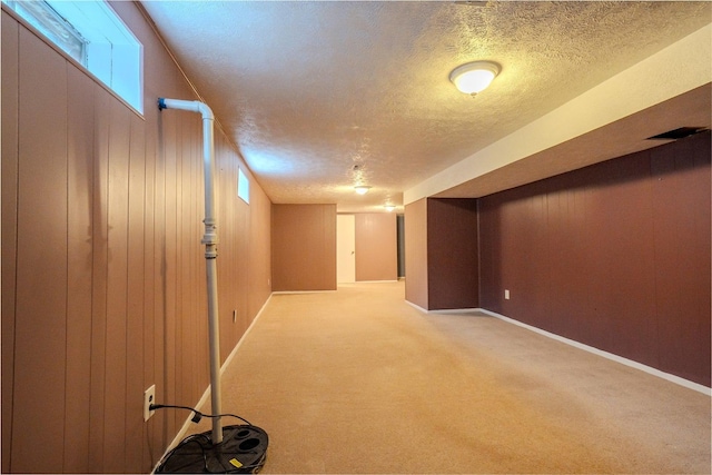 1306 Ewing St, Bloomington, IL 61701 - finished below grade area with carpet flooring, a textured ceiling, and baseboards