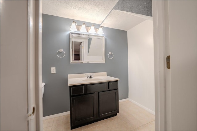 1306 Ewing St, Bloomington, IL 61701 - bathroom featuring a textured ceiling, tile patterned floors, baseboards, and vanity