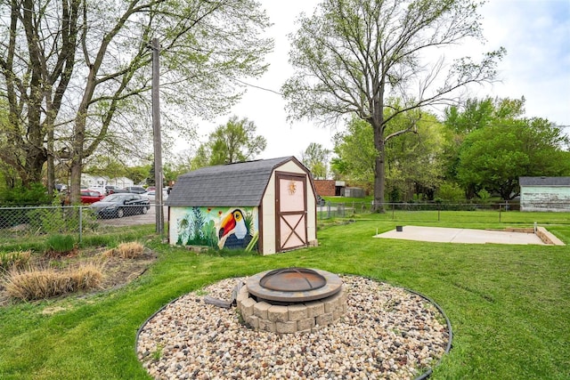 1306 Ewing St, Bloomington, IL 61701 - view of shed featuring a fenced backyard and a fire pit