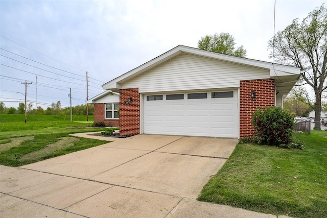 1306 Ewing St, Bloomington, IL 61701 - view of front of home with concrete driveway, brick siding, an attached garage, and a front lawn
