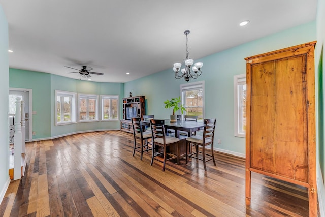 dining space featuring baseboards, recessed lighting, ceiling fan with notable chandelier, and wood-type flooring