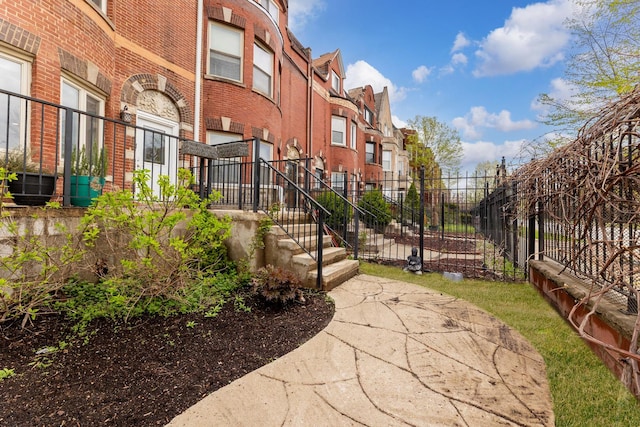 view of community featuring a residential view, stairway, and fence