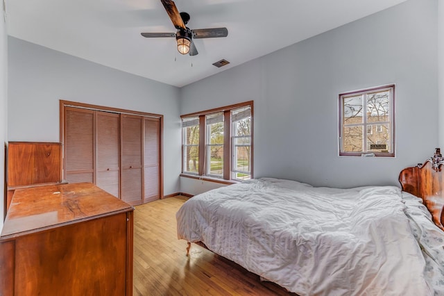 bedroom featuring a closet, ceiling fan, visible vents, and light wood-type flooring