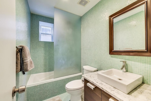 1811 W 17th St Unit 201, Chicago, IL 60608 - bathroom with vanity, toilet, tiled shower / bath, tile walls, and visible vents