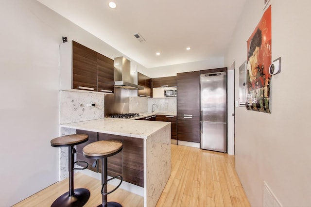 1811 W 17th St Unit 201, Chicago, IL 60608 - kitchen featuring ventilation hood, a peninsula, modern cabinets, and stainless steel appliances