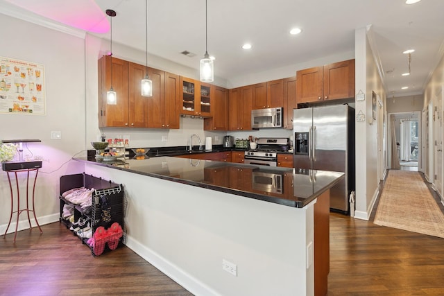 531 N Racine Ave Unit 3, Chicago, IL 60622 - kitchen featuring appliances with stainless steel finishes, a peninsula, brown cabinetry, dark wood finished floors, and crown molding