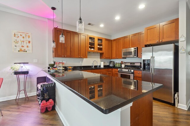 531 N Racine Ave Unit 3, Chicago, IL 60622 - kitchen featuring stainless steel appliances, a peninsula, brown cabinets, dark wood-type flooring, and baseboards
