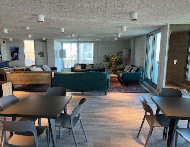 dining space featuring a textured ceiling and wood finished floors