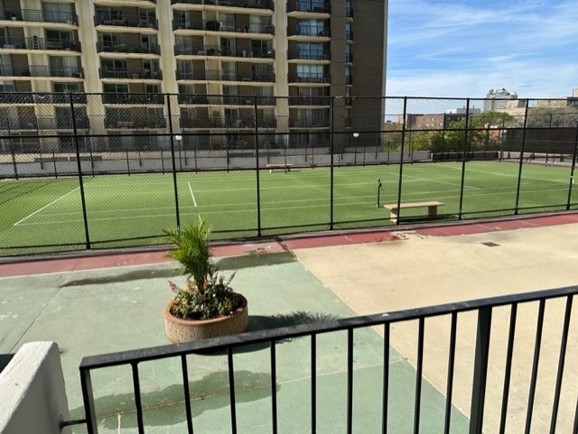 view of home's community featuring fence