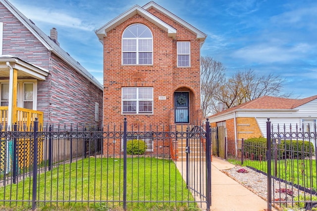 traditional home featuring a front lawn, a fenced front yard, a gate, and brick siding