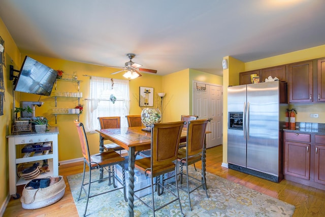 dining area featuring ceiling fan, baseboards, and light wood-style floors