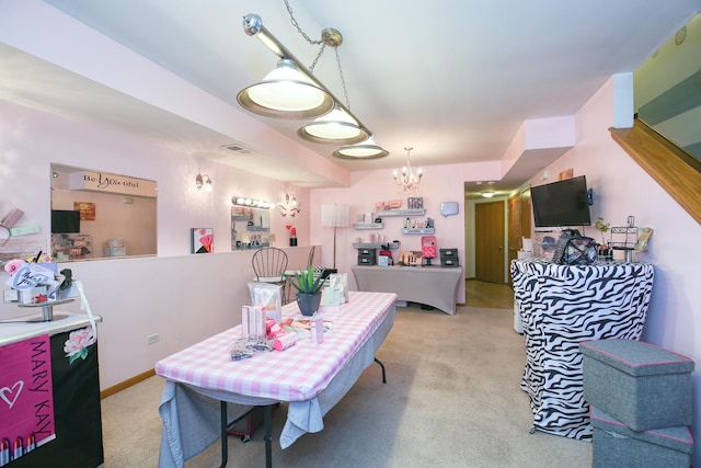 carpeted dining space with an inviting chandelier and visible vents
