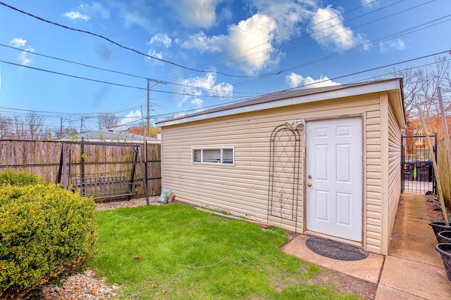 view of outbuilding with a fenced backyard and an outdoor structure
