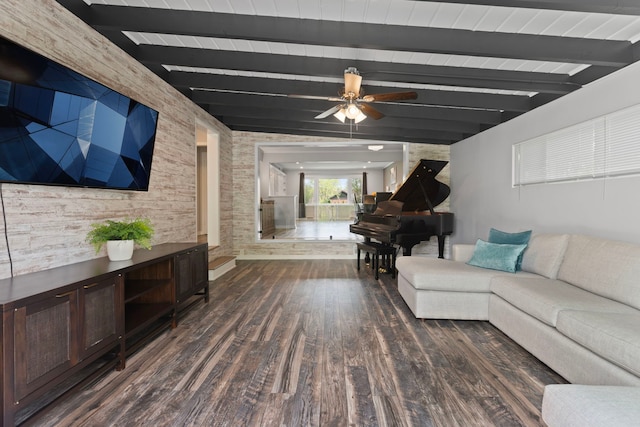 living room with beamed ceiling, a ceiling fan, and wood finished floors