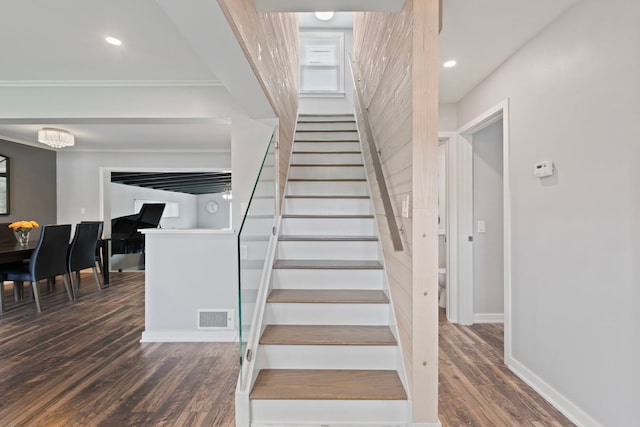 stairs with wood finished floors, visible vents, recessed lighting, crown molding, and baseboards