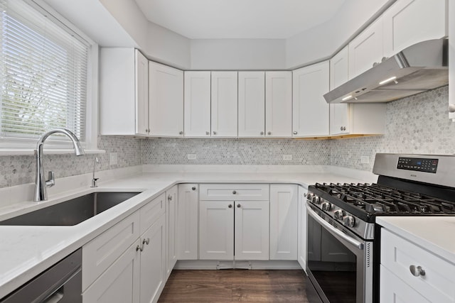 kitchen with dishwashing machine, a sink, stainless steel gas range oven, white cabinets, and under cabinet range hood