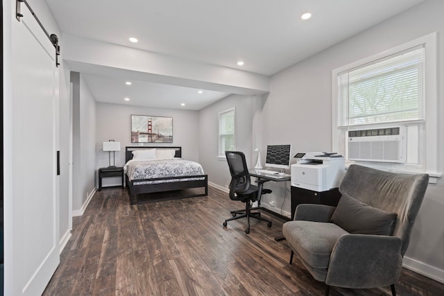 bedroom featuring hardwood / wood-style flooring, a barn door, recessed lighting, cooling unit, and baseboards