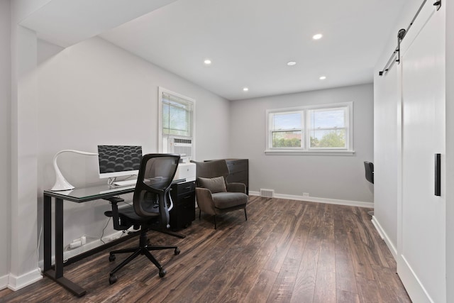 office with a barn door, recessed lighting, baseboards, dark wood-style flooring, and visible vents