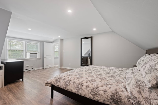 bedroom featuring wood finished floors, recessed lighting, vaulted ceiling, baseboard heating, and baseboards