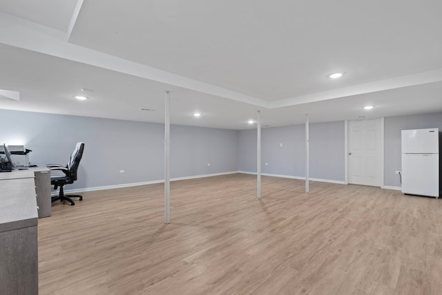 finished below grade area with freestanding refrigerator, light wood-style floors, baseboards, and recessed lighting